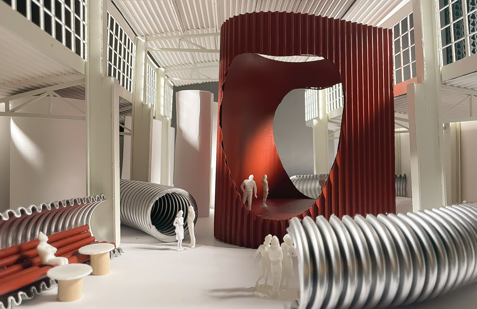 Physical model of the Biomachina restaurant: a red corrugated volume with an oval opening, silver ducts and white figures