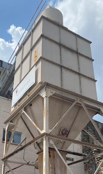 Site visit: a tall industrial silo against the sky
